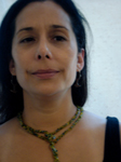 Dr. Luna smiles into the camera. She is on a white background. She has black hair and is wearing a green beaded necklace and a black top.